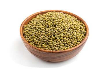 Wooden bowl with raw green mung bean isolated on white background. Side view.