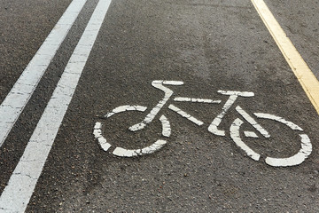 yellow and white asphalt bike path