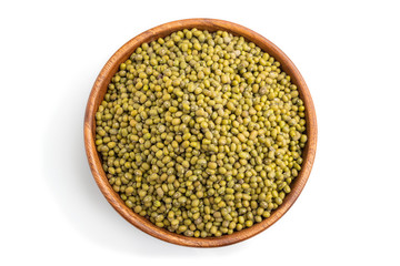 Wooden bowl with raw green mung bean isolated on white background. Top view.