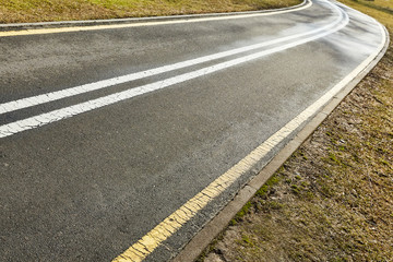 Fototapeta premium yellow and white asphalt bike path