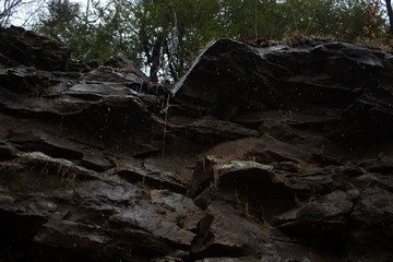 Water dripping off a rocky cliff