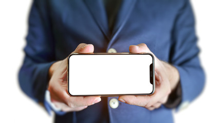 Businessman holds a smartphone horizontally in his hands on white isolated background. White screen. Place for template or screenshot