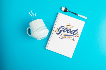 Blue coffee mug on a blue background with the text Good Morning