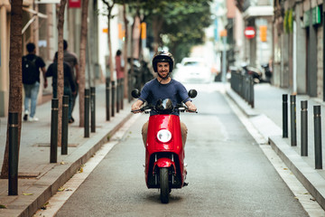 guy smiling with motorcycle in Barcelona