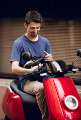 Fototapeta na wymiar Close up Biker boy with black helmet sitting on red motorcycle