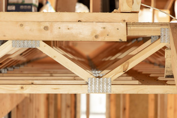 Frame house under construction. Wooden structures with shallow depth of field. Frame of a new building