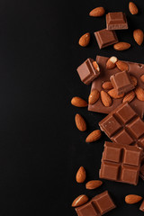 Chocolate with almonds and cinnamon on a dark background, Copy space