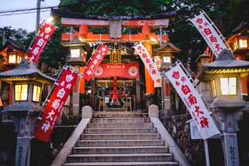 Sanctuary with lamps and flags at Fushimi Inari taisha shrine, Kyoto