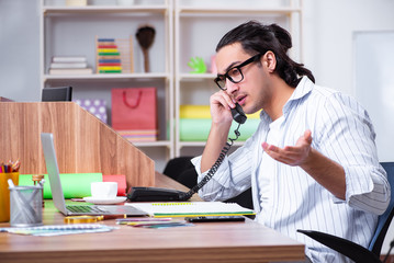 Young male designer working in the office