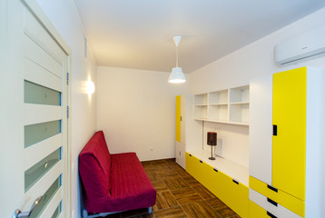 Children's room in the cottage. Bunk bed, window with blue curtains, large wardrobe with yellow...