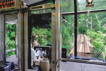 Train driver and forest view at Mount Kurama, Kyoto, Japan