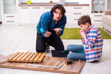 Young carpenter teaching his son