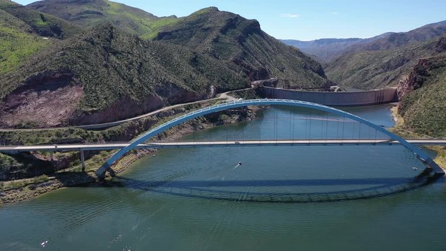A 4k high definition aerial view of the Theodore Roosevelt Lake dam and bridge,