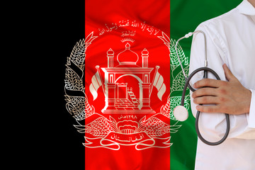 doctor in uniform with a stethoscope against the background of the silk national flag of Afghanistan, the concept of medical care in the country, insurance, treatment