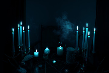 in a dark room on a round esoteric table candles burn, smoke, animal skulls lie, a pentagram is...