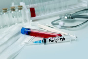 medical laboratory test tube with blood inside, stethoscope, syringe, protective masks, concept of...