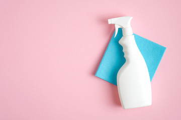 White cleaner spray bottle and blue rag. Flat lay, top view. House cleaning service and...