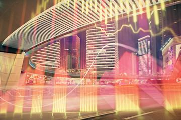 Forex chart on cityscape with tall buildings background multi exposure. Financial research concept.