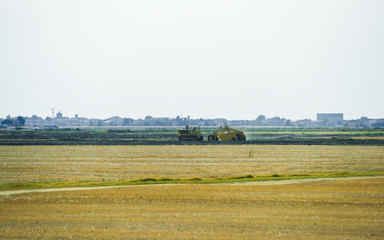 Fototapeta na wymiar Tractor doing agricultural work in field of Austria summer