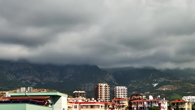 Mass of clouds over mountains and town Mahmutlar Turkey on a sunny summer day