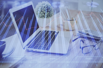 Double exposure of chart and financial info and work space with computer background. Concept of...