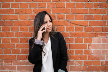 Latin woman talking on the phone.