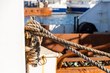 Lines wrapped tightly around cleat on fishing boat