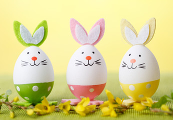 Three easter bunny eggs with flower