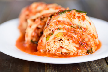 Kimchi cabbage on white plate, homemade Korean food	