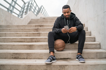 Athletic man using his mobile phone.