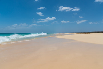 Fototapeta na wymiar Sandy beach of Santa Monica in Boa Vista, Cape Verde under the blue sky