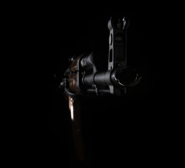 The barrel of a Kalashnikov AK-47 assault rifle on a black background