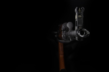 The barrel of a Kalashnikov AK-47 assault rifle on a black background