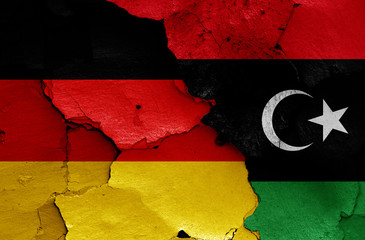 flags of Germany and Libya painted on cracked wall