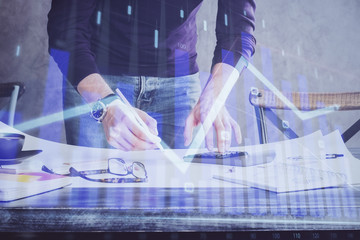 Multi exposure of man standing and planing investment with stock market forex chart.