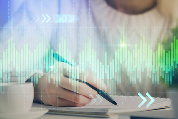 Forex chart displayed on woman's hand taking notes background. Concept of research. Multi exposure