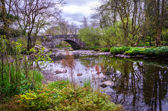 A view of Skelwith Bridge showing the river of Brathay running under the bridge.  