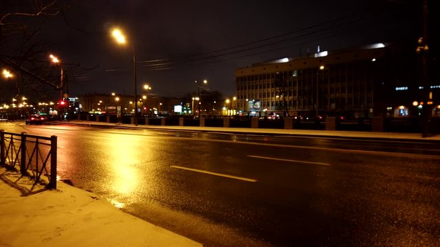 Timelapse of the night winter road with blurred lights of cars