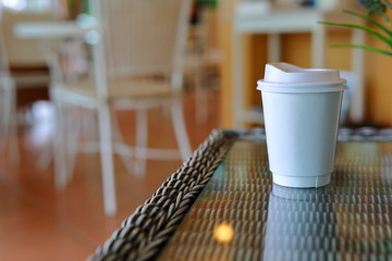 take away cup for hot coffee drink put on glass table in cafe shop