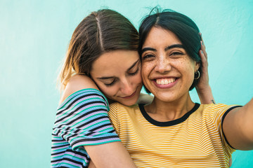 Lovely lesbian couple taking a selfie.