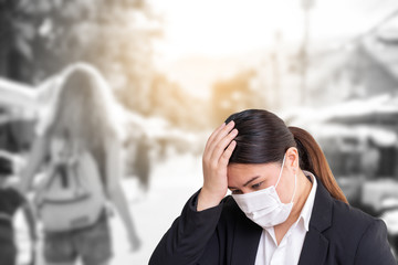 Asian woman wearing surgical mask to prevent flu disease Corona virus with blurred image of crowded