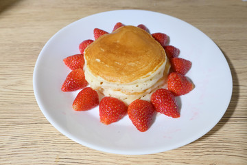 pancake and strawberry fruit sweet dessert food put on breakfast table