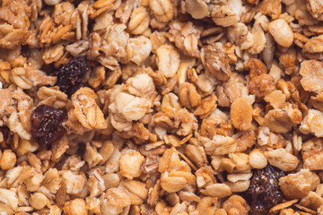 Useful and tasty muesli with nuts, rasins and flakes. Selective focus macro shot with very shallow depth of field. Healthy and vegetarian lifestyle