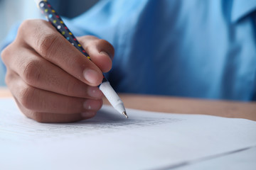 Close up of man hand writing on paper 