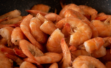 Delicious shrimps in black pan