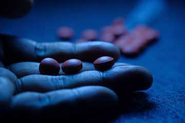Close up of man hand taking drugs 