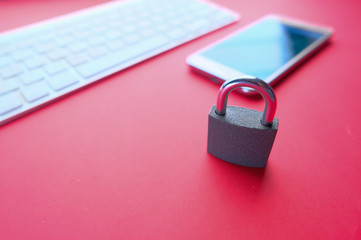 Close up of padlock and smart phone on color background 