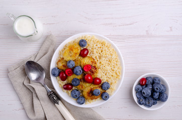 Wheat porridge with fruit and berries