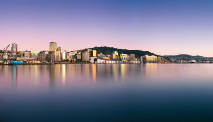 Wellington city buildings and skyline reflected in the harbour at sunrise on a perfect summer...