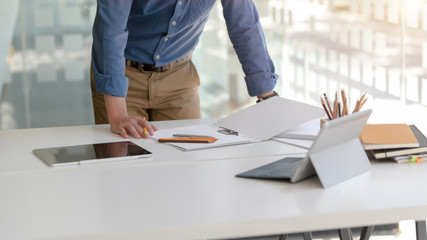 Cropped shot of businessman focusing on his work with digital tablets